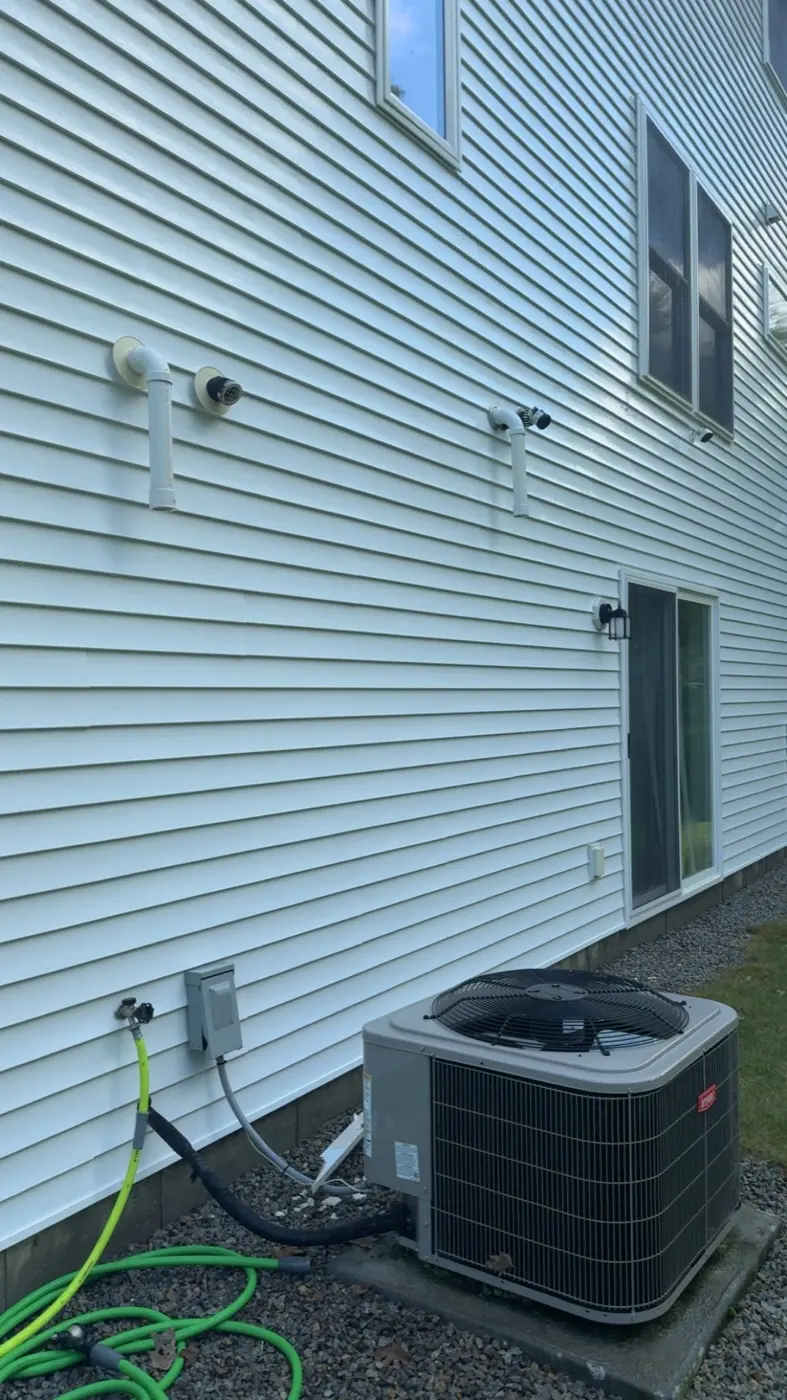 After: the same white siding clean and bright after a soft wash